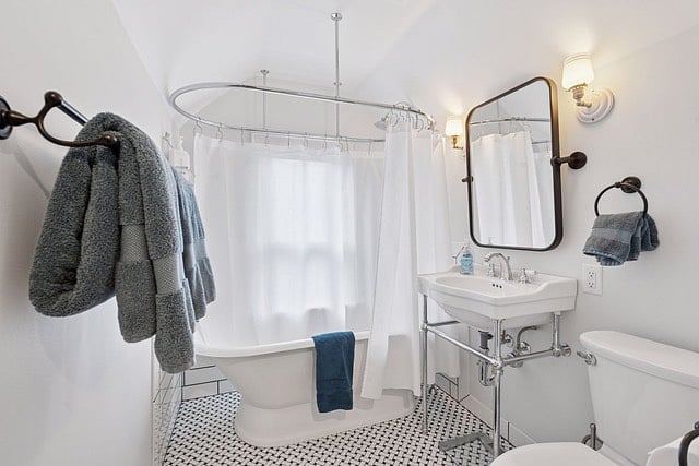 Upstairs bathroom with claw tub and stand up shower.