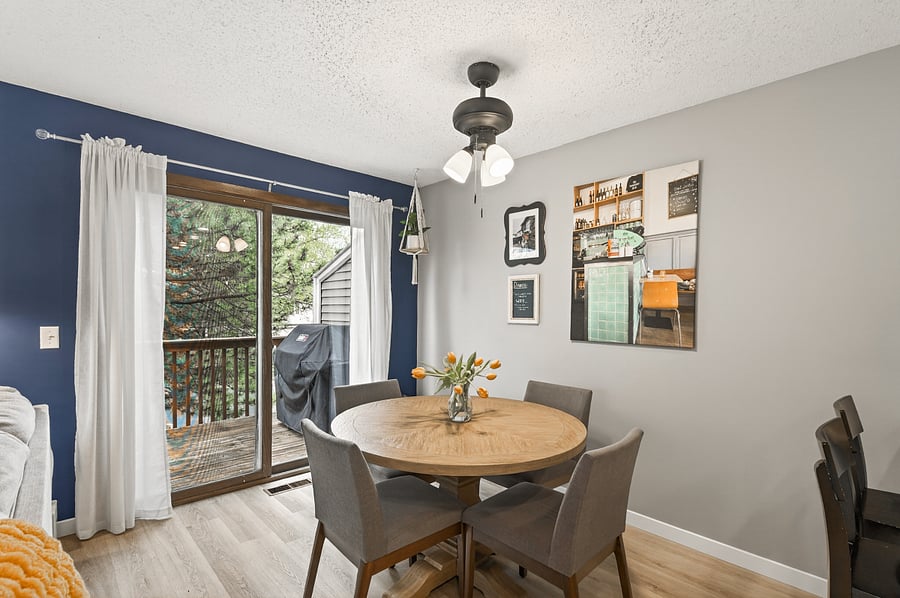 Dining area with seating for 4 looking out the patio door to the deck.