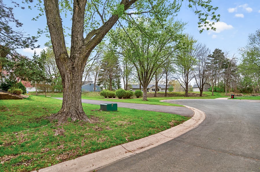 Outside view of the side of house, the cul de sac and in the distance you can see the entrance to the trail.