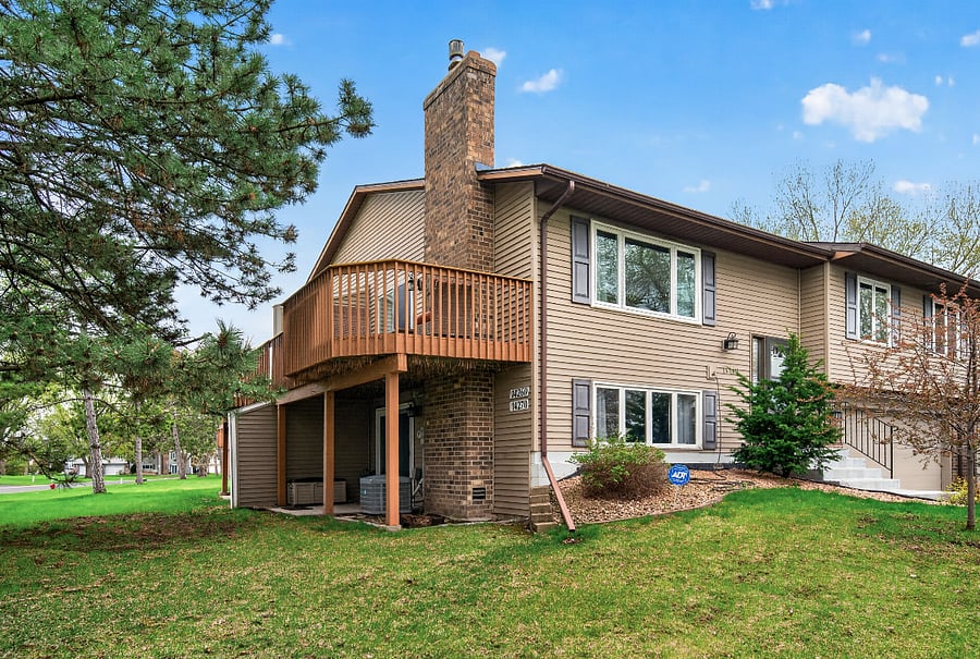 View of house and deck from driveway.