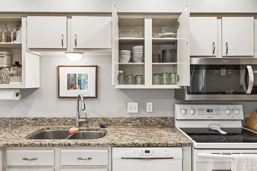 Open cabinets showing some dishes and glasses.