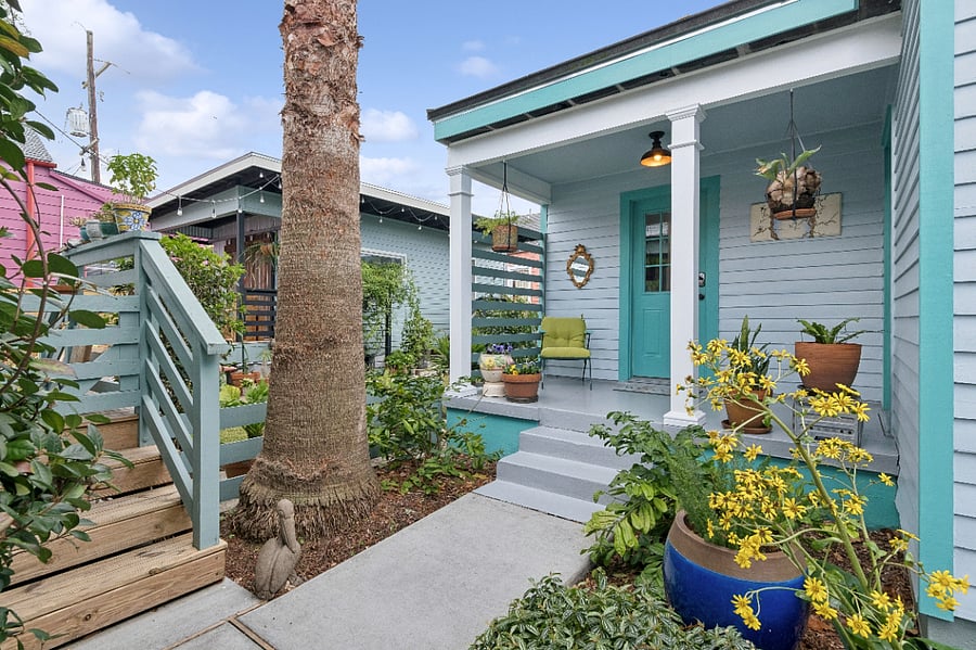 To the left are stairs that lead to the owners porch. While close in proximity, lush greenery allows for ample privacy. The shed, located to the left of the cottage is used for owner storage.