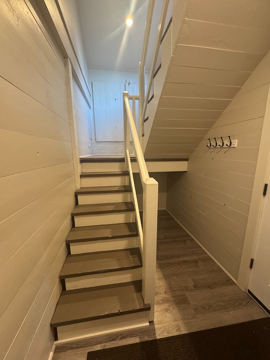 Wide entry way stairs with plenty of indoor storage for items like bikes, golf clubs, skis.