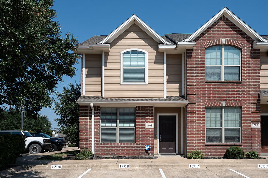 Front of unit with reserved parking spaces.