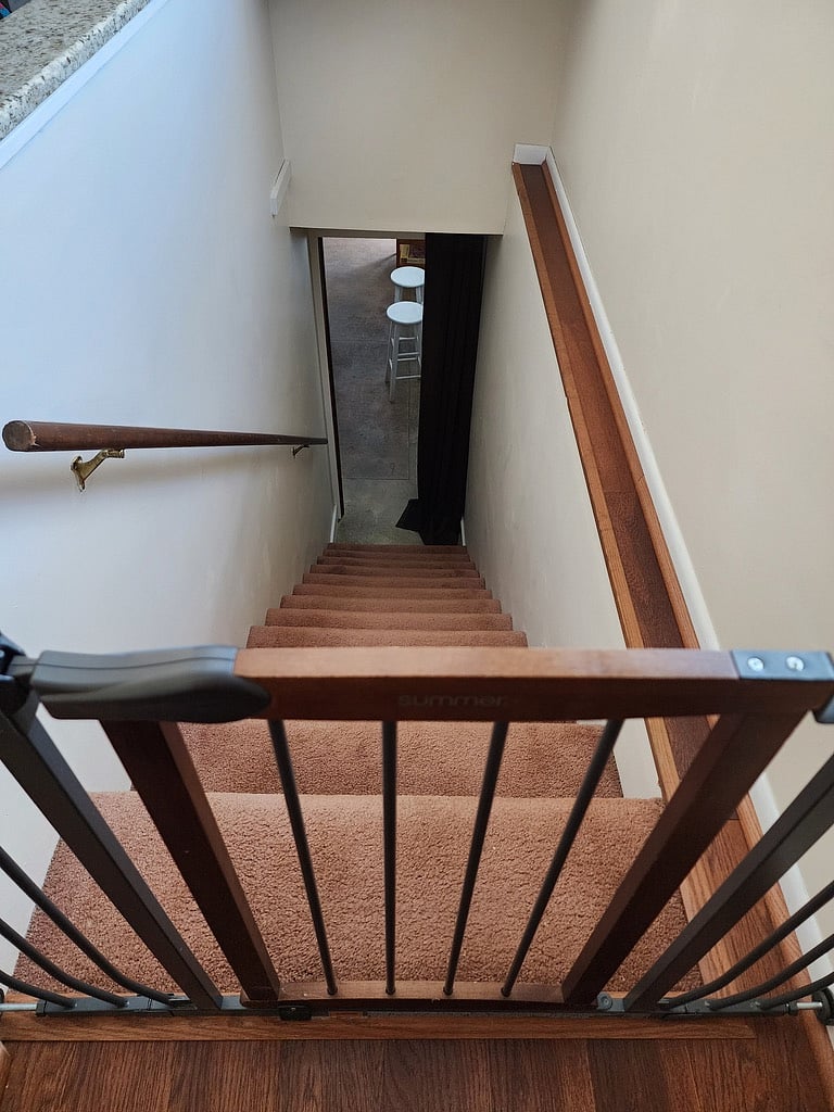 staircase between upstairs and downstairs. Door has a locking mechanism with a code.