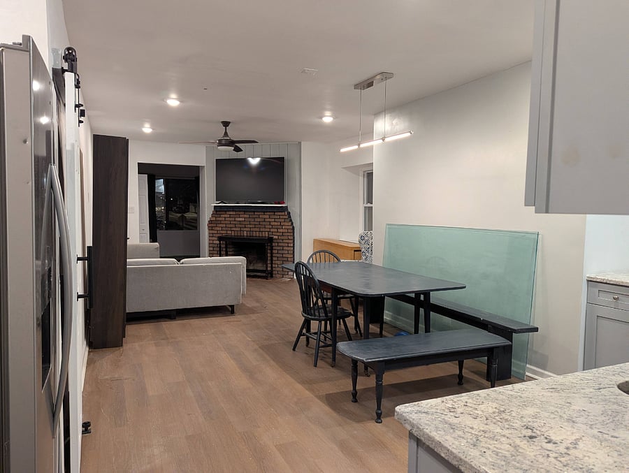 Spacious dining room & kitchen with large dining table and seating.