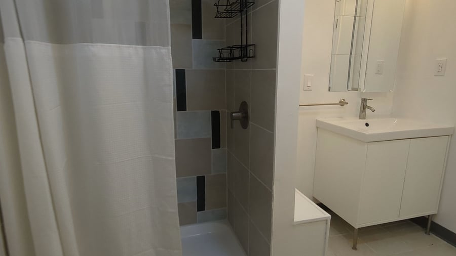 Large walk-in shower with large shower caddy for all of your bathing and pampering needs.
