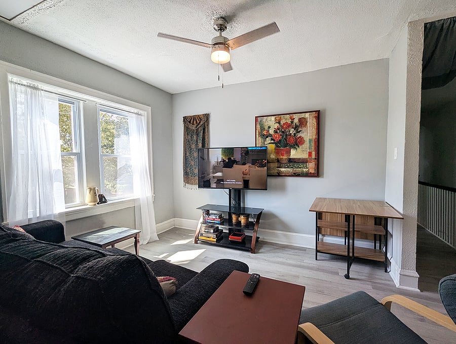 Living Room with Smart TV, games, bookes & puzzles and a collapsable table and stools for company!