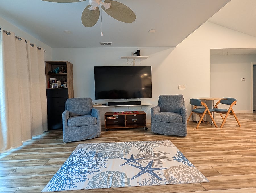 Living room sofa chairs and coffee table. 75" Samsung Smart TV