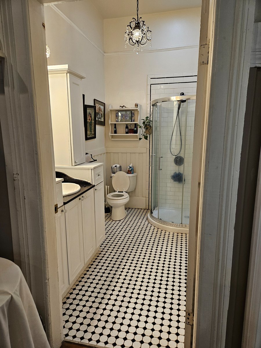 Storage both sides of sink, above and below. Rain shower head and hand held shower head.