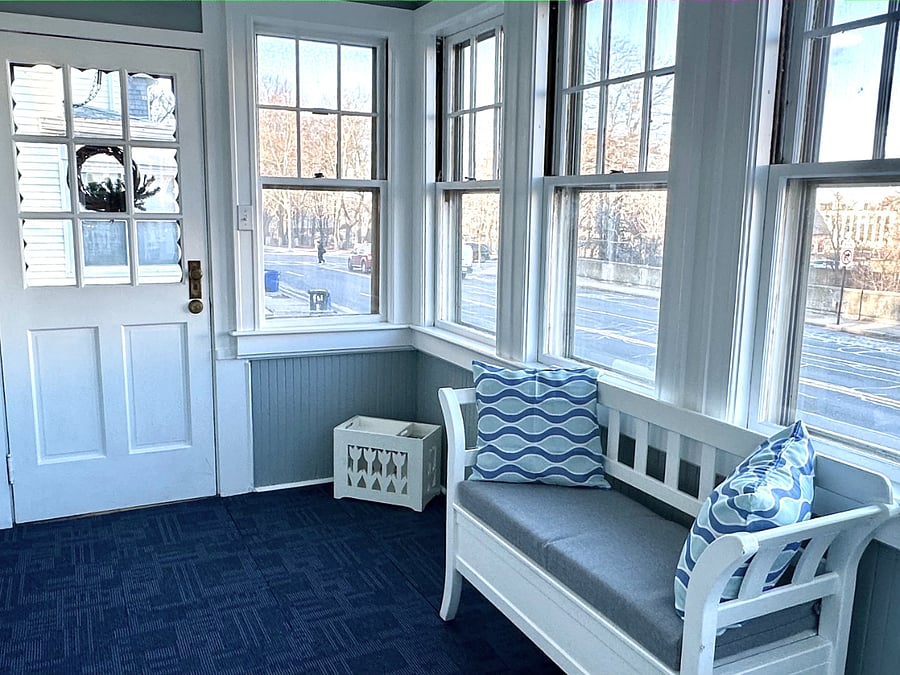Private front entry into bright sunroom providing bonus square footage. Flooded with natural light all day. Whether sipping your morning coffee, working from home, or unwinding with a good book, this sun drenched enclosed 4-season room is a favorite!