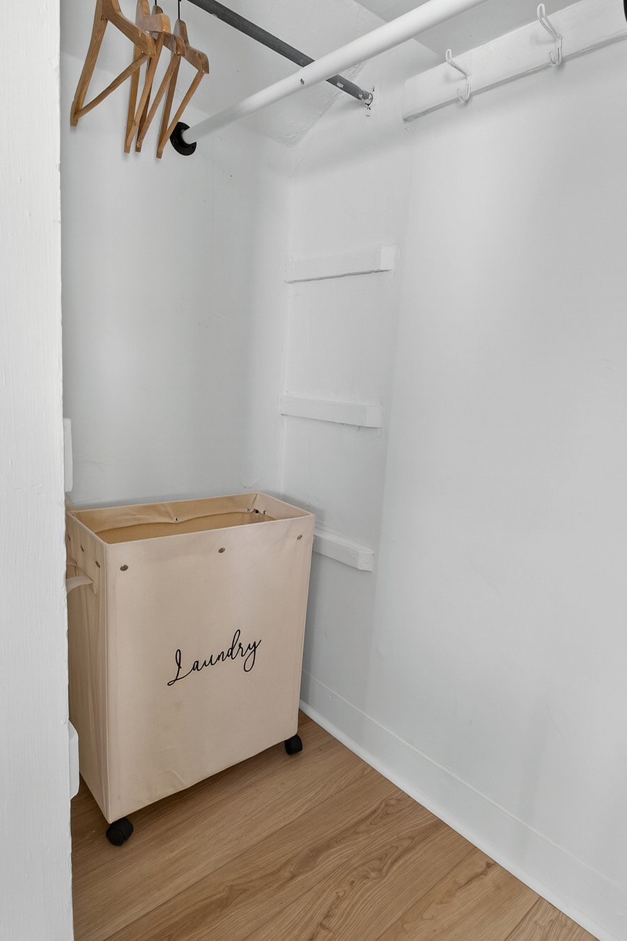 Bedroom 3 includes a closet with convenient hangers and a laundry basket, enhancing comfort and functionality.