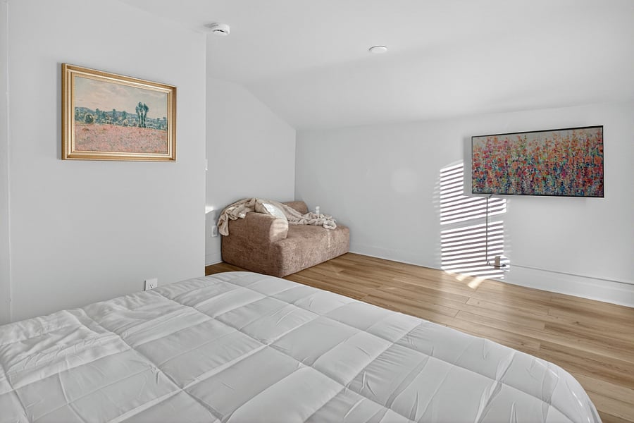 Bedroom 3 offers a cozy queen bed, a plush modular cloud chair, and a Smart TVperfect for unwinding.