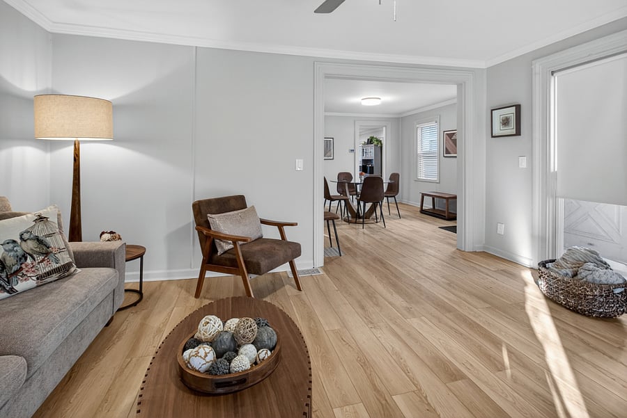 The living room offers a clear view of the dining area and entryway, enhancing the open and connected feel of the space.