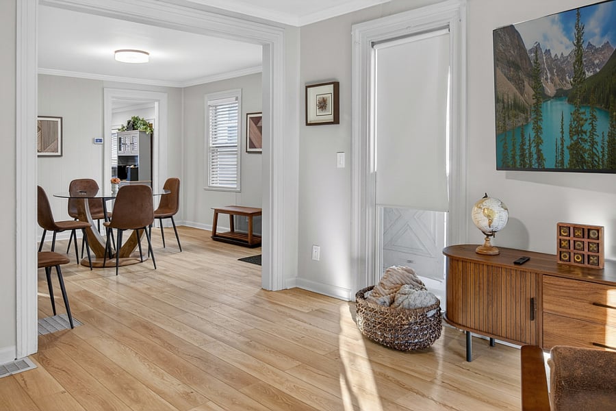 The living room offers a clear view of the dining area and entryway, enhancing the open and connected feel of the space.
