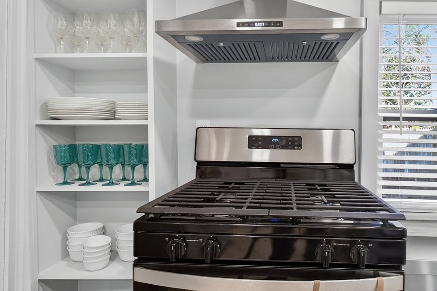 The kitchen includes a full range and oven, providing everything needed for convenient home cooking.