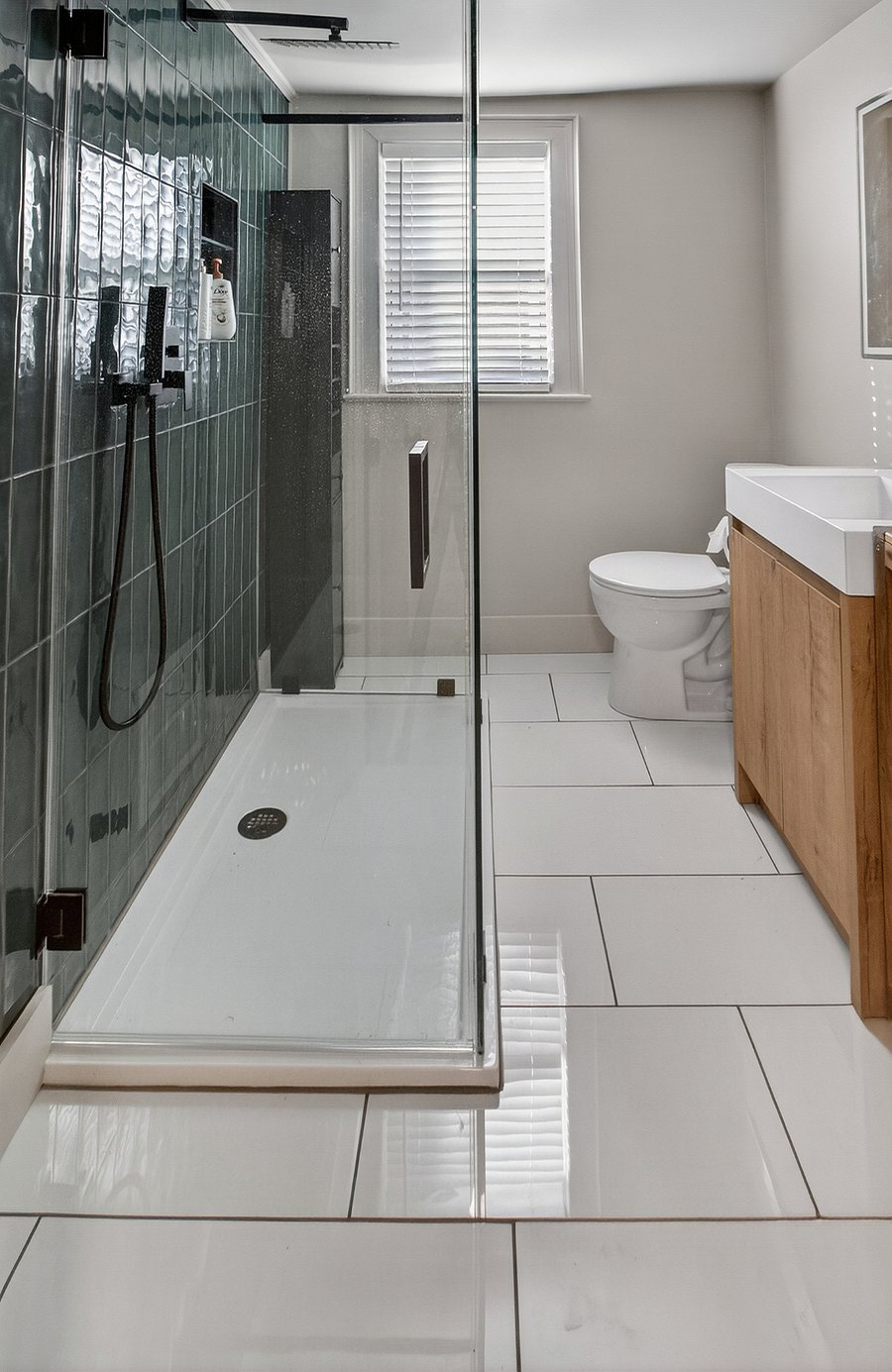 The bathroom features a shower-only layout and is stocked with body soap, shampoo, and conditioner. A blow dryer and a Levoit Core Smart Air Purifier are also provided for added comfort and convenience.