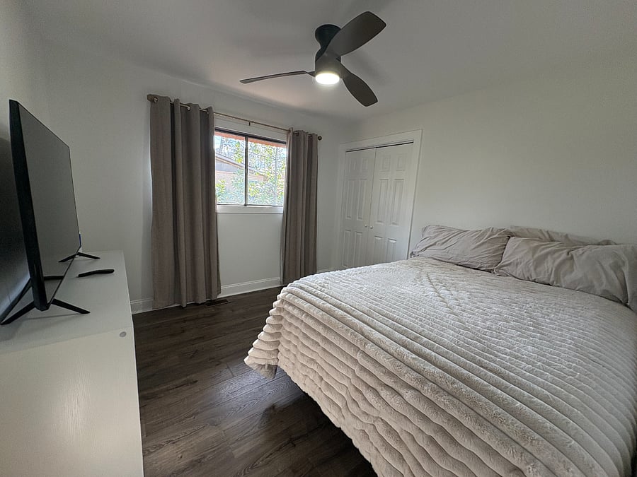 Guest bedroom with a Queen size bed and 55 inch smart TV