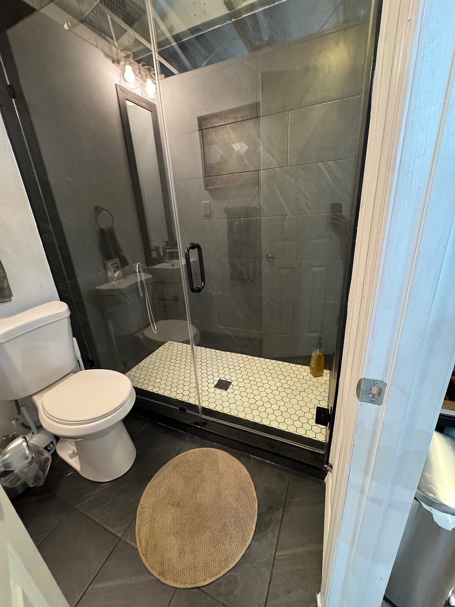 Newly renovated Large walk in shower with rain shower head .