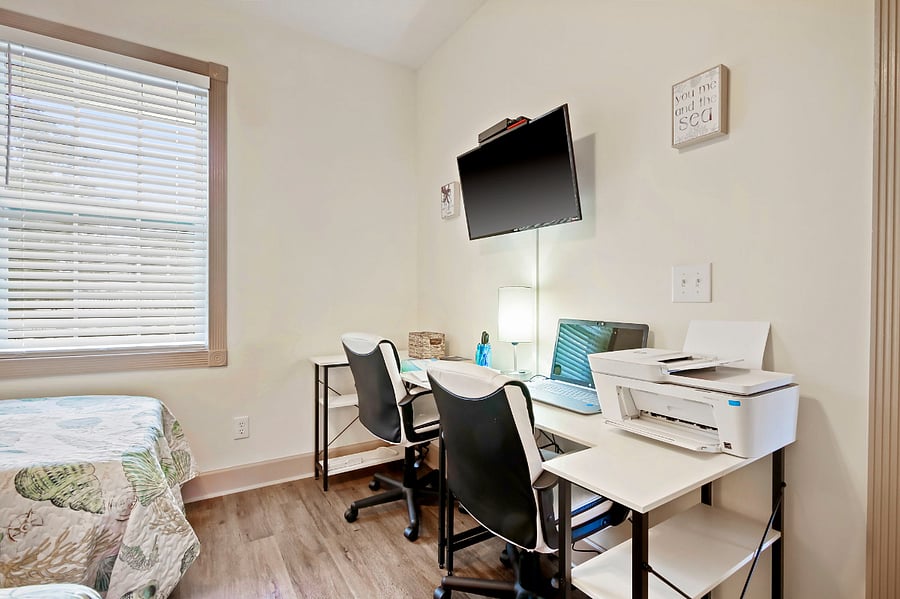There are double desks and two chairs for gaming or working.
