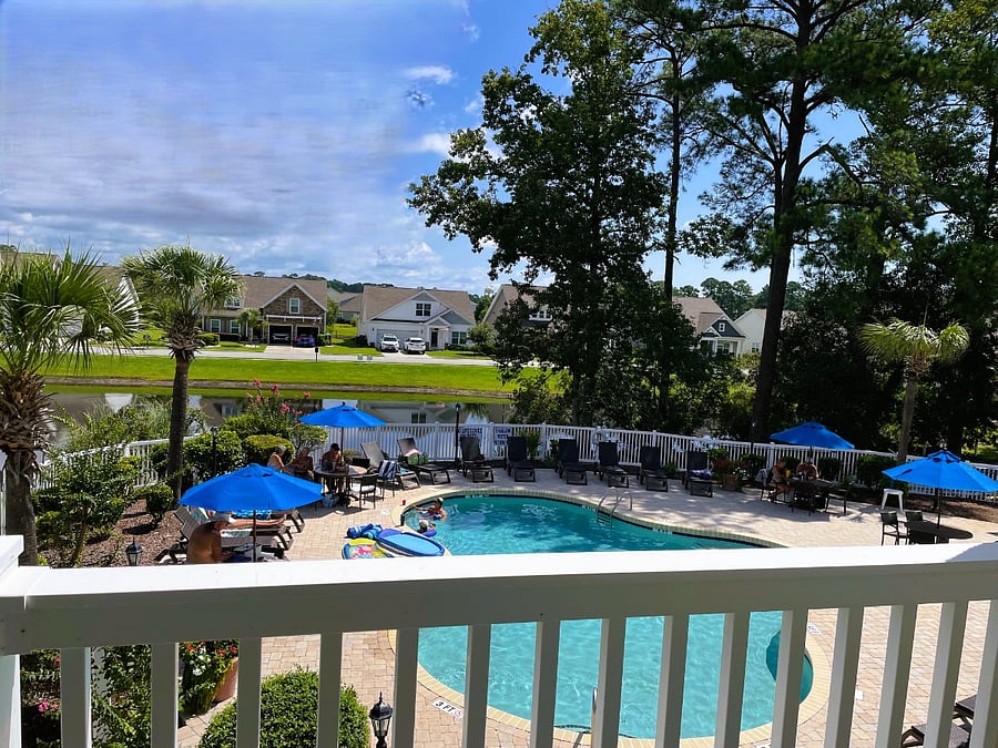 The condo overlooks a pool and pond.