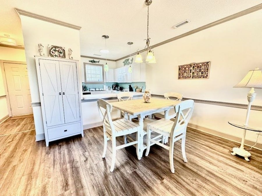 There is a pantry cabinet for extra storage, and the table seats four, with two extra barstools at the counter.