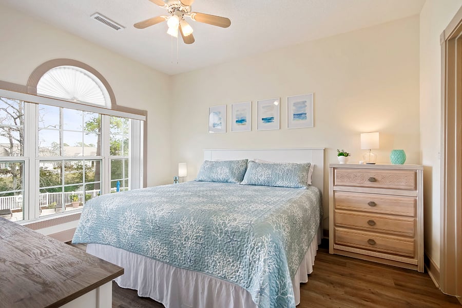 The main bedroom has a nightstand, dresser, walk-in closet and desk.
