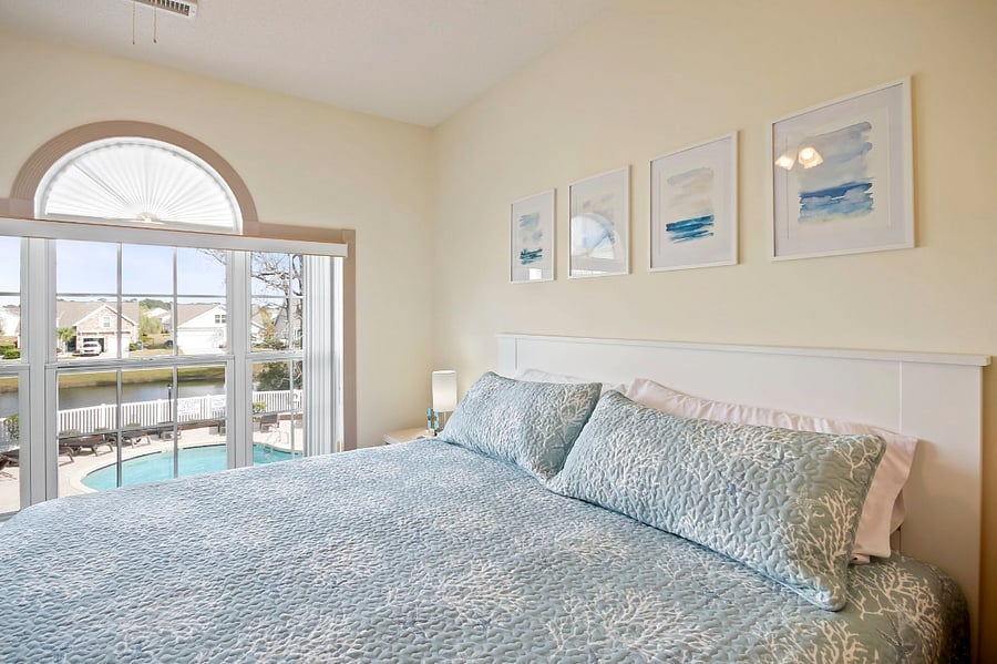 The main bedroom overlooks the pool and pond.