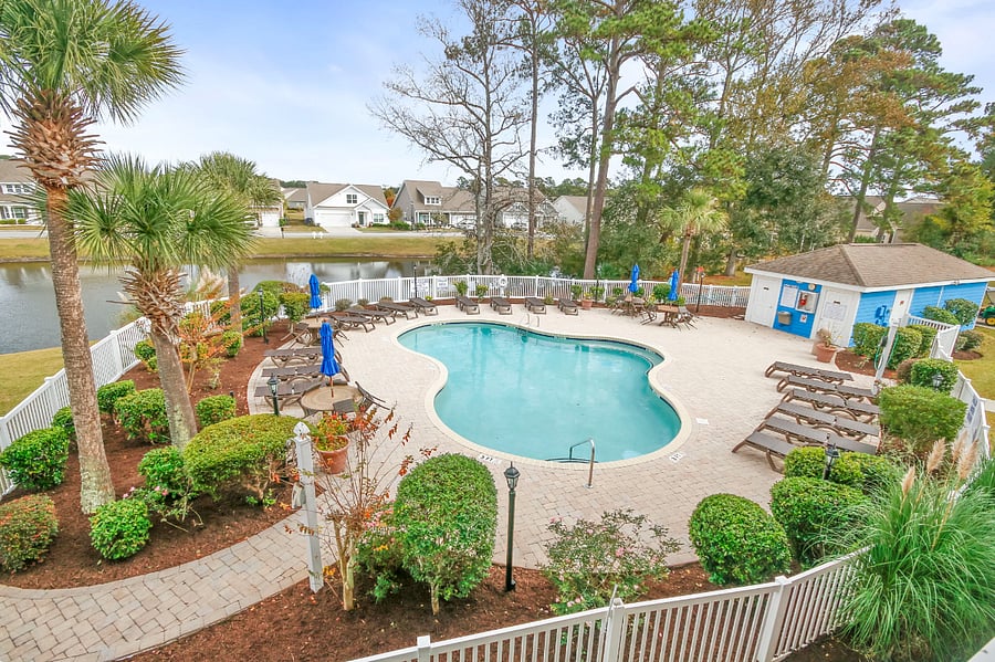 The pool is open seasonally and there are lots of lounge chairs and tables.