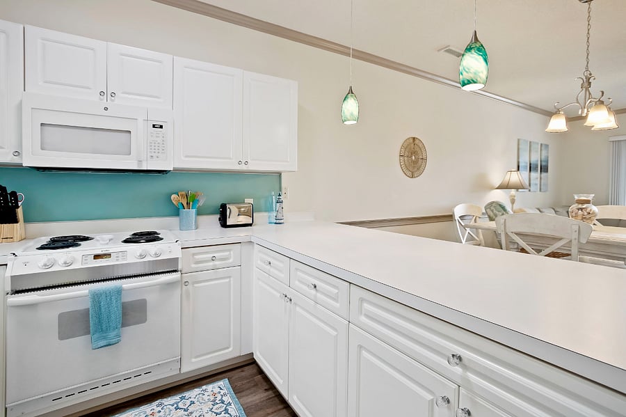 The kitchen has counter seating with open views to the dining/living room area.