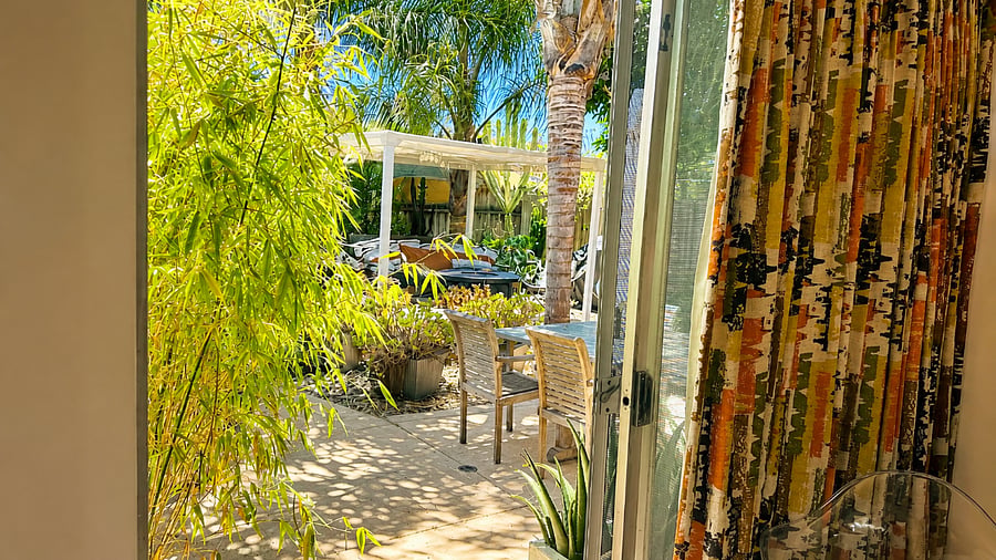 Step outside and enjoy seamless access to the lush tropical garden.