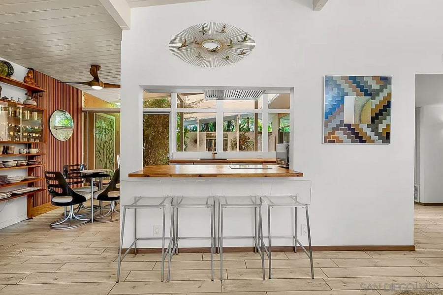 The dining area connects seamlessly to the private atrium beyond.