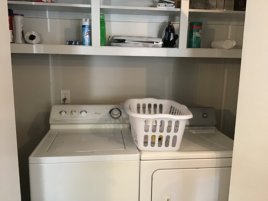 Laundry closet.  This area contains a full size washer and dryer and is located behind folding doors near kitchen area.  Some cleaning items, an iron and small ironing board are placed here. 