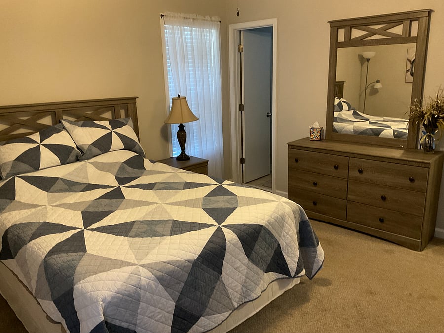 Master bedroom.  This bedroom contains a queen bed, a dresser with mirror, chest of drawers, TV, chair and a walk-in closet. 