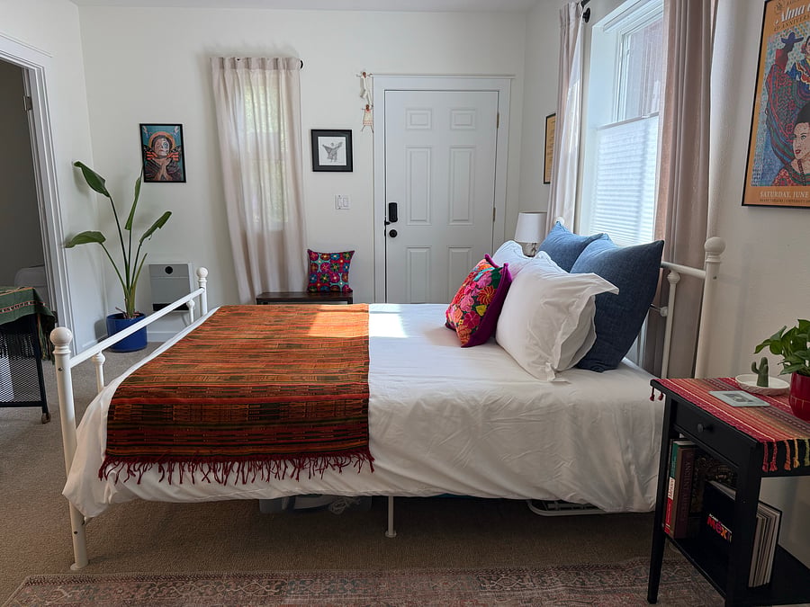 Lots of natural light. Windows are furnished with blinds and curtains.