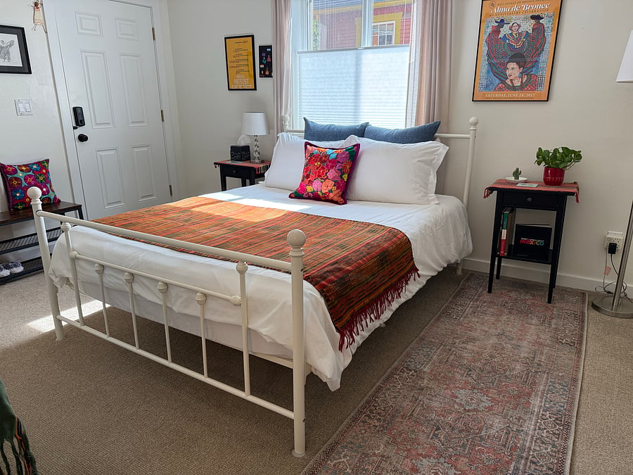 Queen size mattress with fresh bed linens.