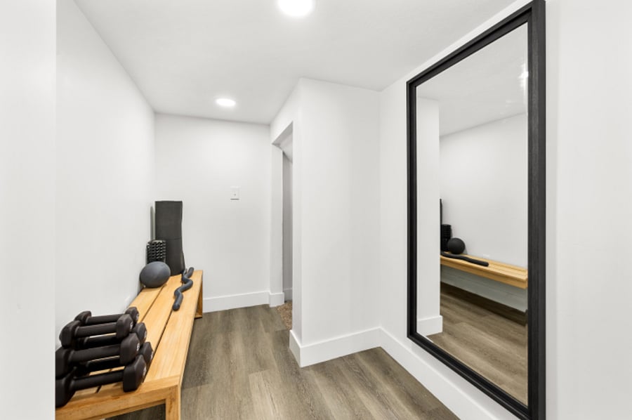 Workout space with gym yoga mat, weights, and Bala bar and ball