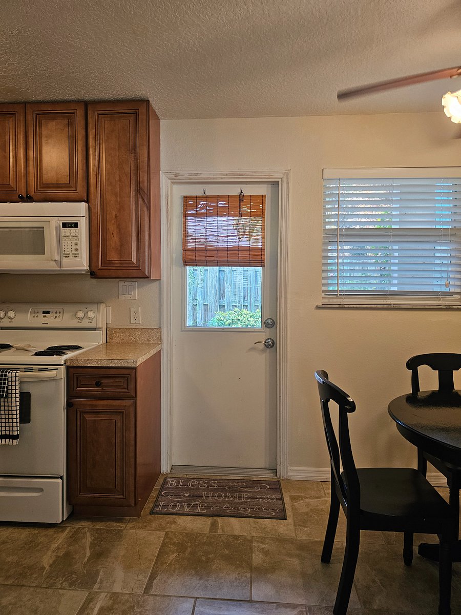 Large fully equipped kitchen, and door to the back yard.