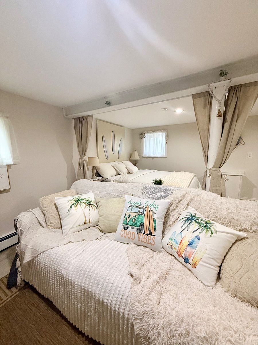 Coastal Vibe living room/bedroom area.  Curtains pull shut to create a privacy space between the 2 areas. 