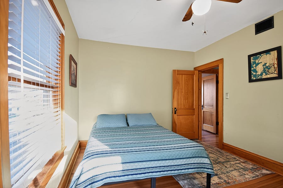 Cozy wooden bedroom retreat in Omaha. Unwind in classic comfort after a day exploring the city.