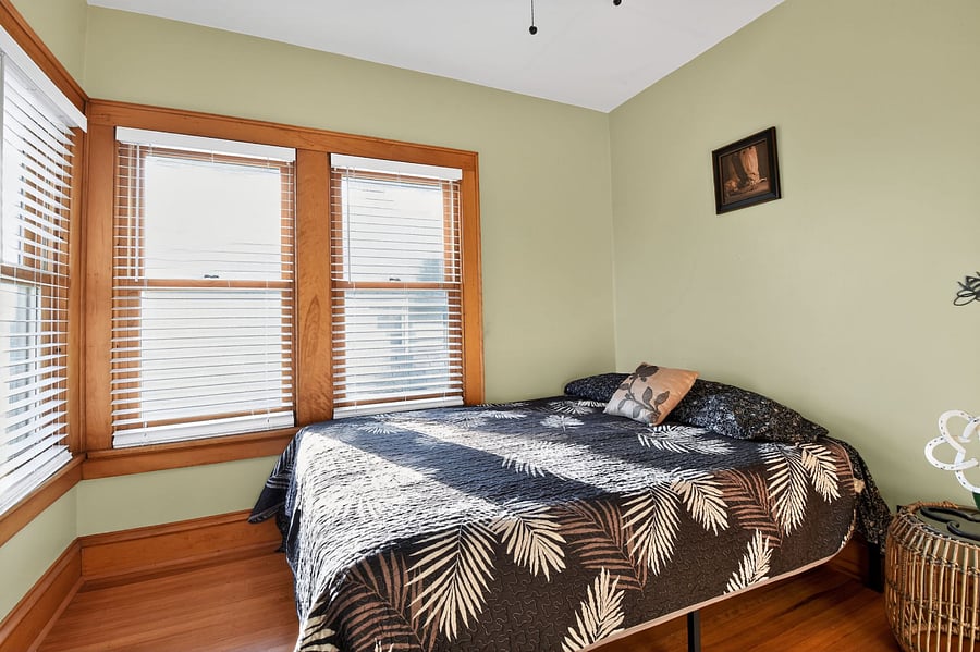 Relax in this warm Omaha bedroom featuring timeless wooden dcor and plush bedding.
