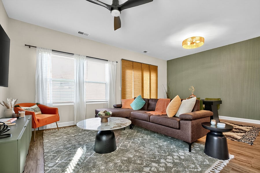 Sunlight pours through wide windows, giving this living area a cheerful, relaxing feel. Unwind after a day exploring Greenville or local attractions.