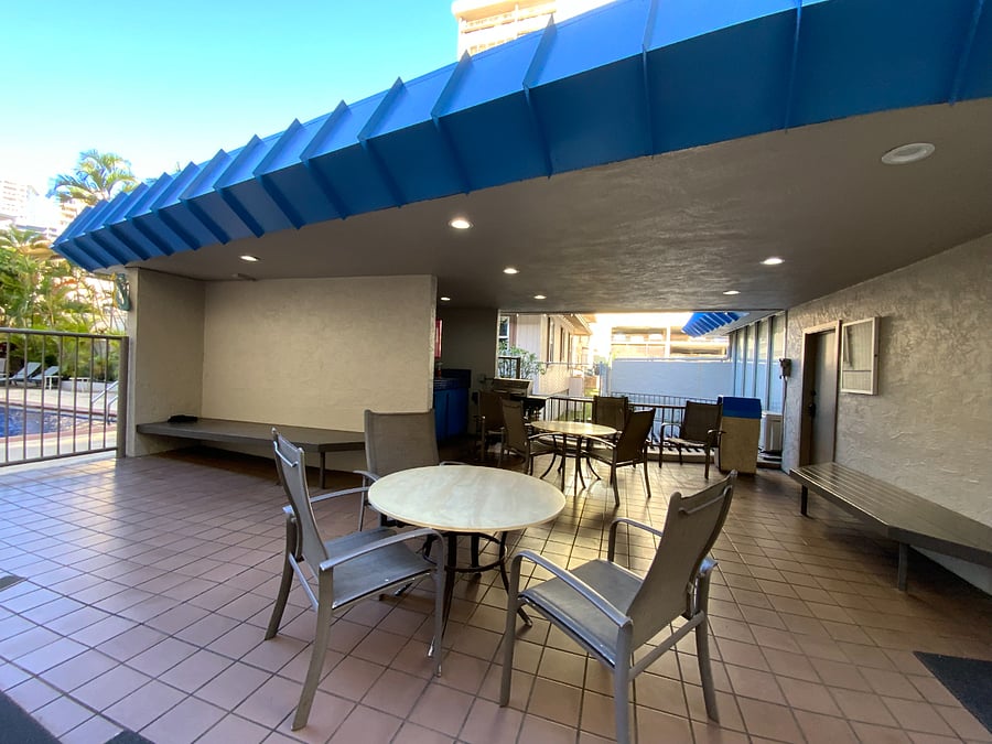 BUILDING BBQ AND SITTING AREA OUTSIDE POOL.  DOOR TO GYM ON RIGHT SIDE