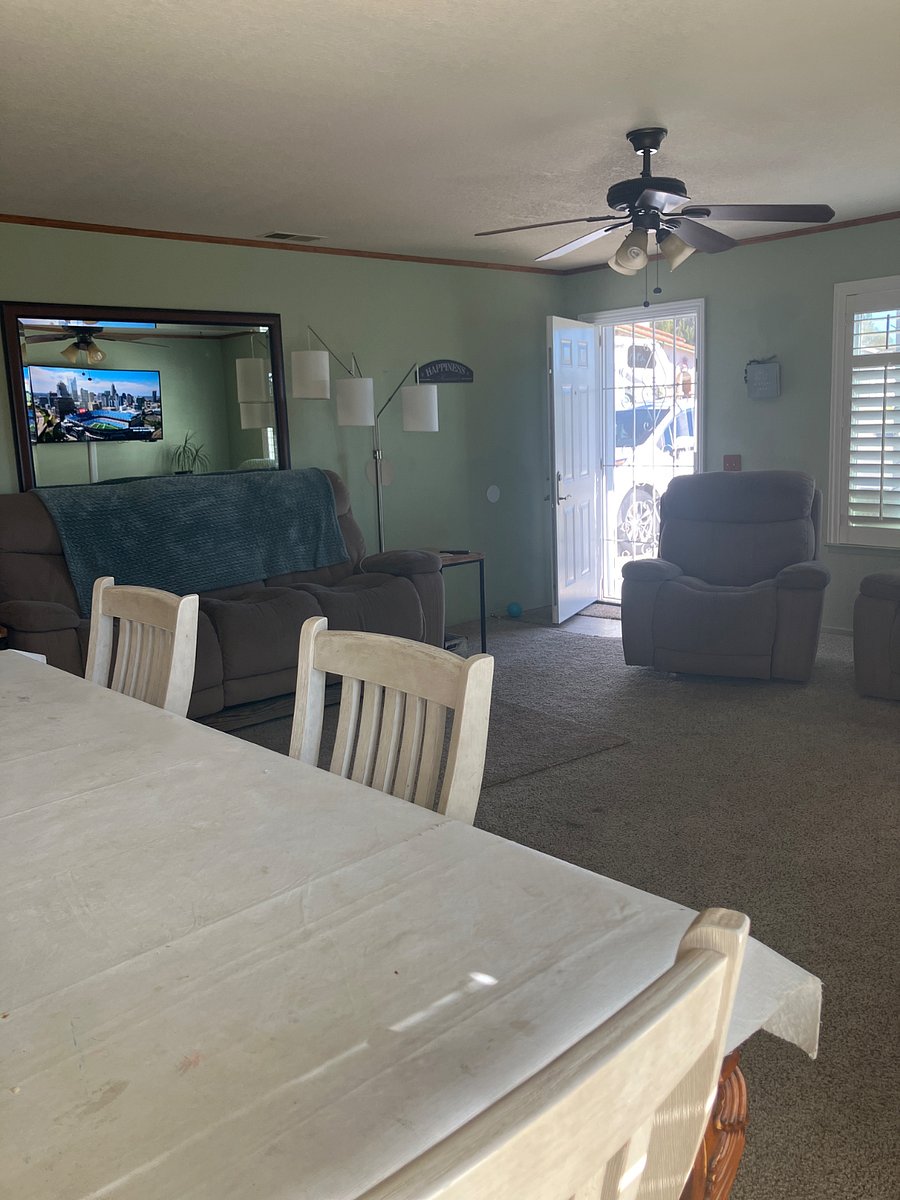 Living room has two sofas and a rocking chair that all recline