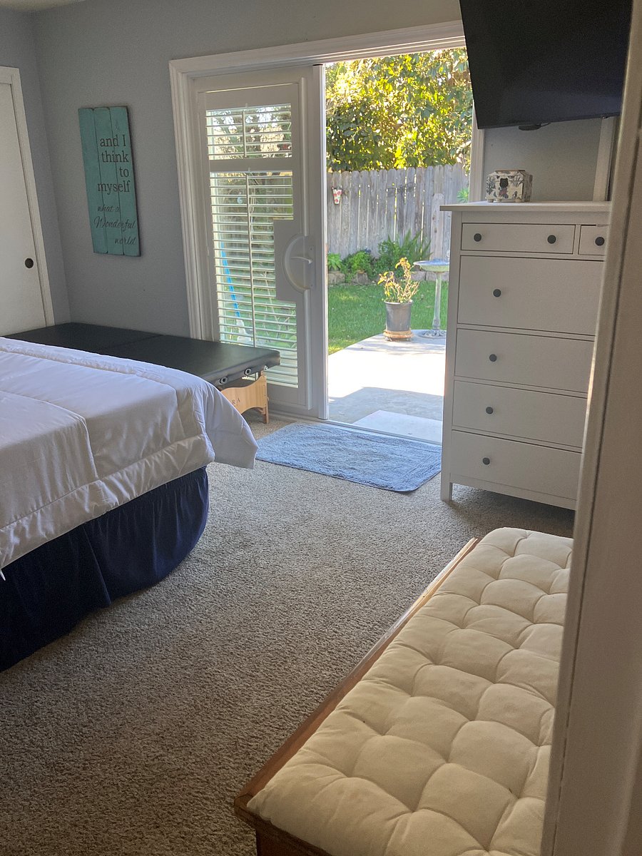 French doors leading out to the backyard from the master bedroom, Jacuzzi right outside