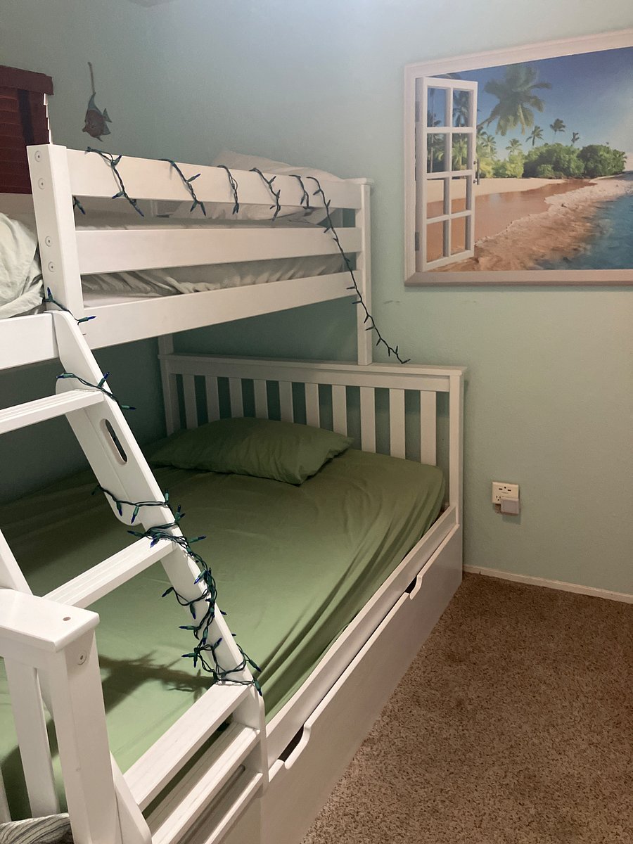 This is a bunkbed with a full bed in the middle, sleeps four at the most