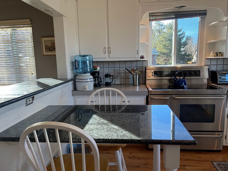 Granite topped breakfast nook / cooking island and double oven range