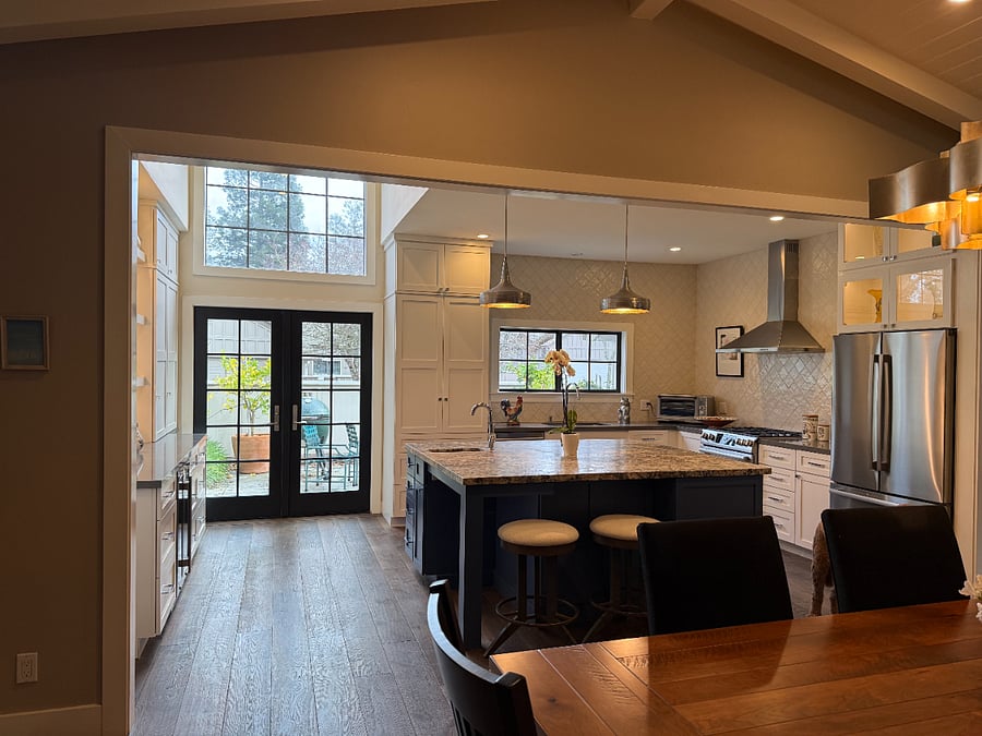 French doors from the kitchen lead to the front courtyard and the Big Green Egg