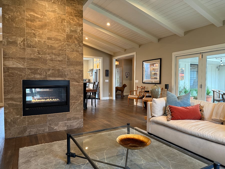 2 sided fireplace provides ambience to living room and dining room