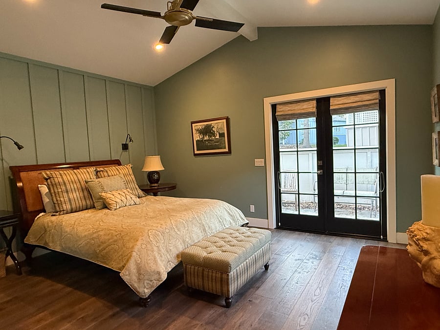 French doors from the primary bedroom lead to the back courtyard